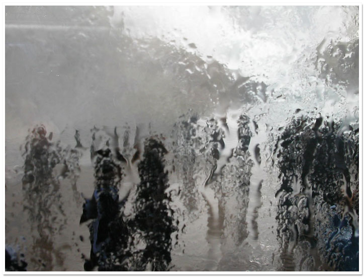 figures behind a wet train window